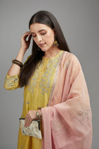 Yellow straight kurta set with silver zari embroidery and round neckline with button placket in the front