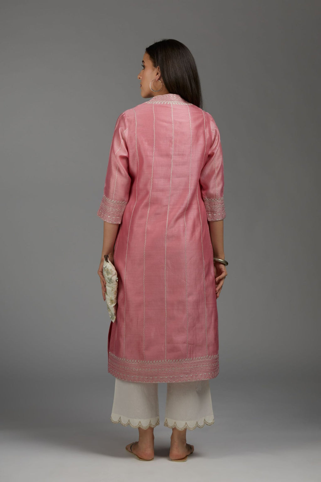 Pink straight kurta set with all-over silver zari embroidery and V neckline with one functional button in front