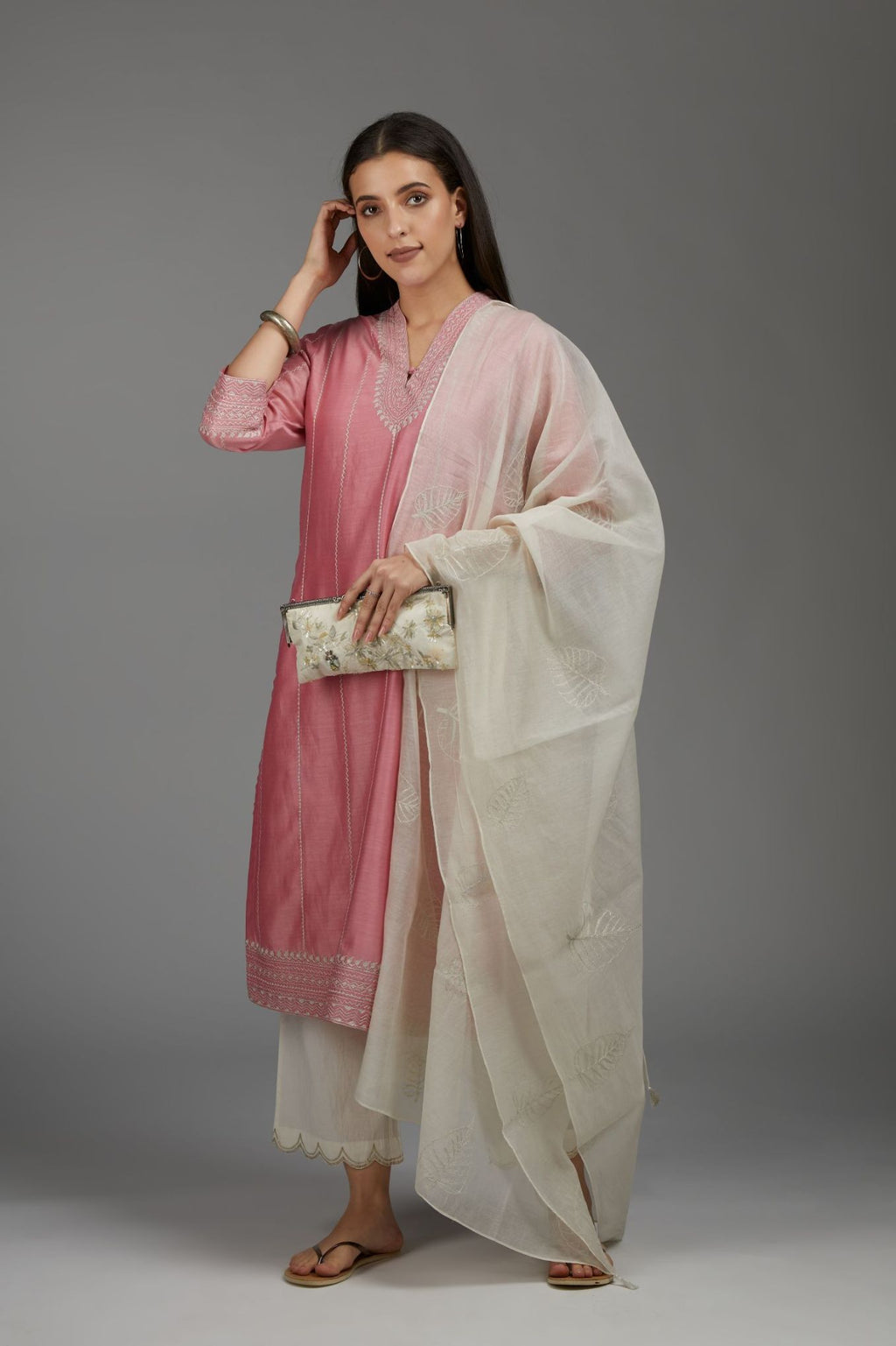 Pink straight kurta set with all-over silver zari embroidery and V neckline with one functional button in front