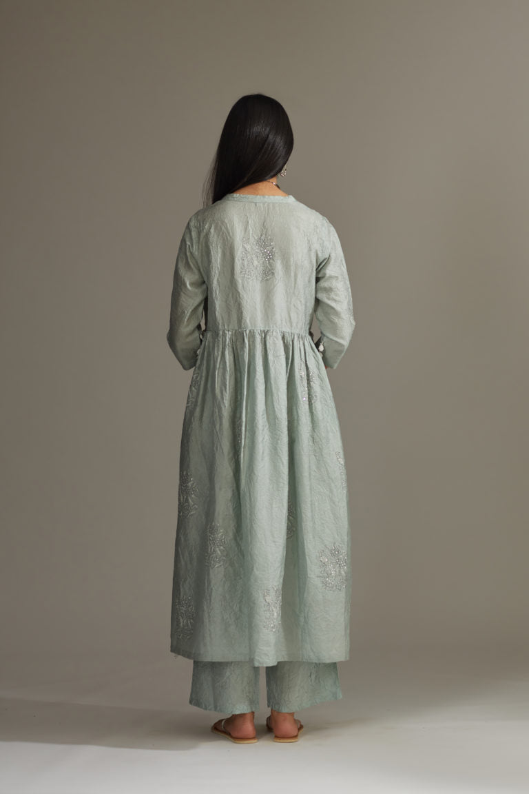 Sea blue hand-crushed silk kurta set with wavy empire waistline and gathers, highlighted with delicate sequins embroidery