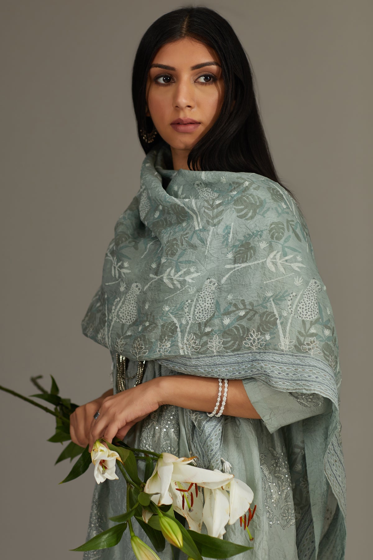 Sea blue hand-crushed silk kurta set with wavy empire waistline and gathers, highlighted with delicate sequins embroidery