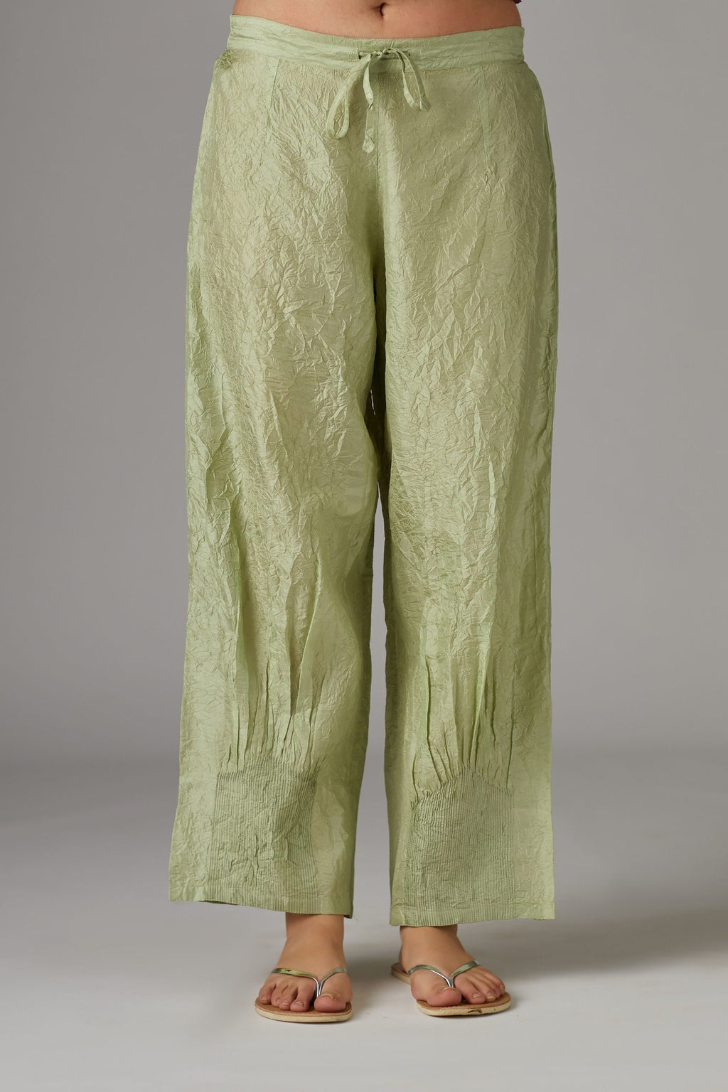 Apple green straight crushed silk pants with pin tucks at hem