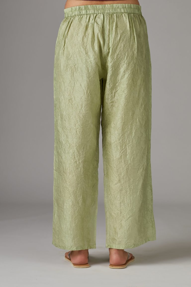 Apple green straight crushed silk pants with pin tucks at hem