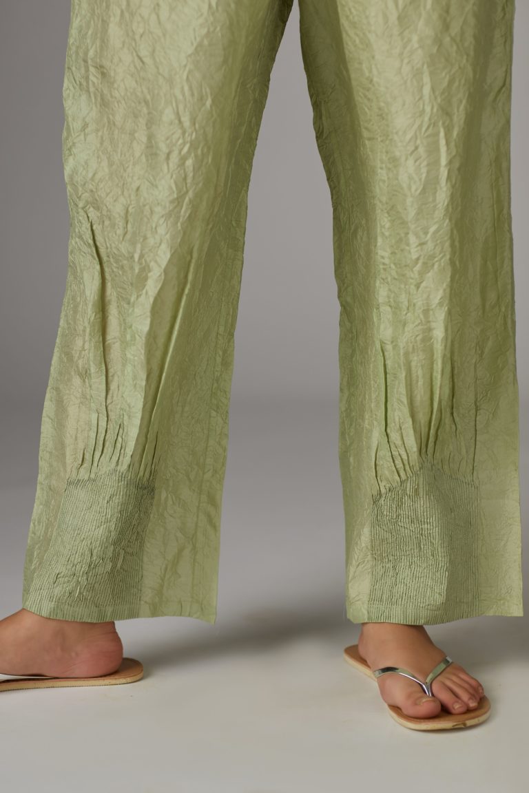 Apple green straight crushed silk pants with pin tucks at hem