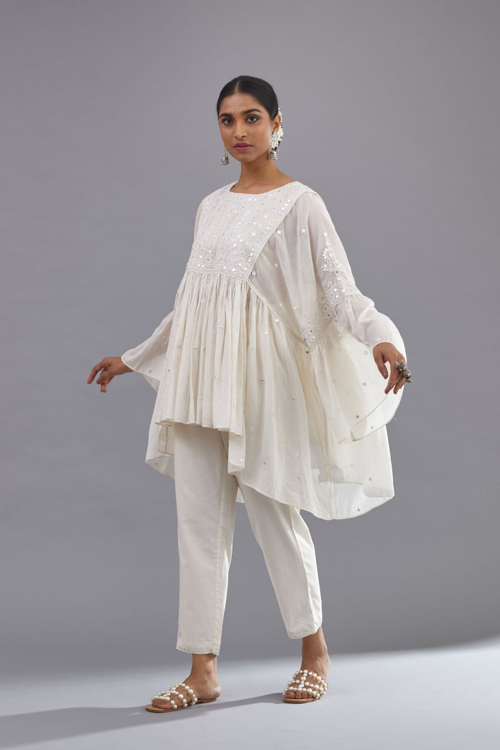Off white cotton easy fit top with flared sleeves and hem, paired with off white cotton comfortable fit pant with all-over elasticated waistband.