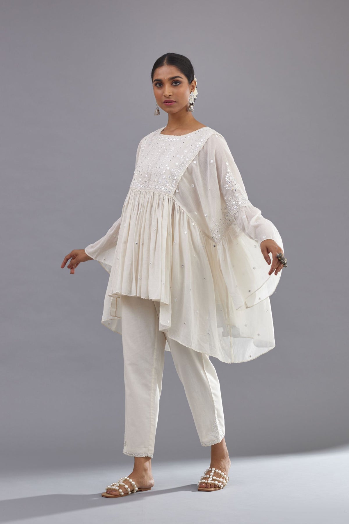 Off white cotton easy fit top with flared sleeves and hem, paired with off white cotton comfortable fit pant with all-over elasticated waistband.