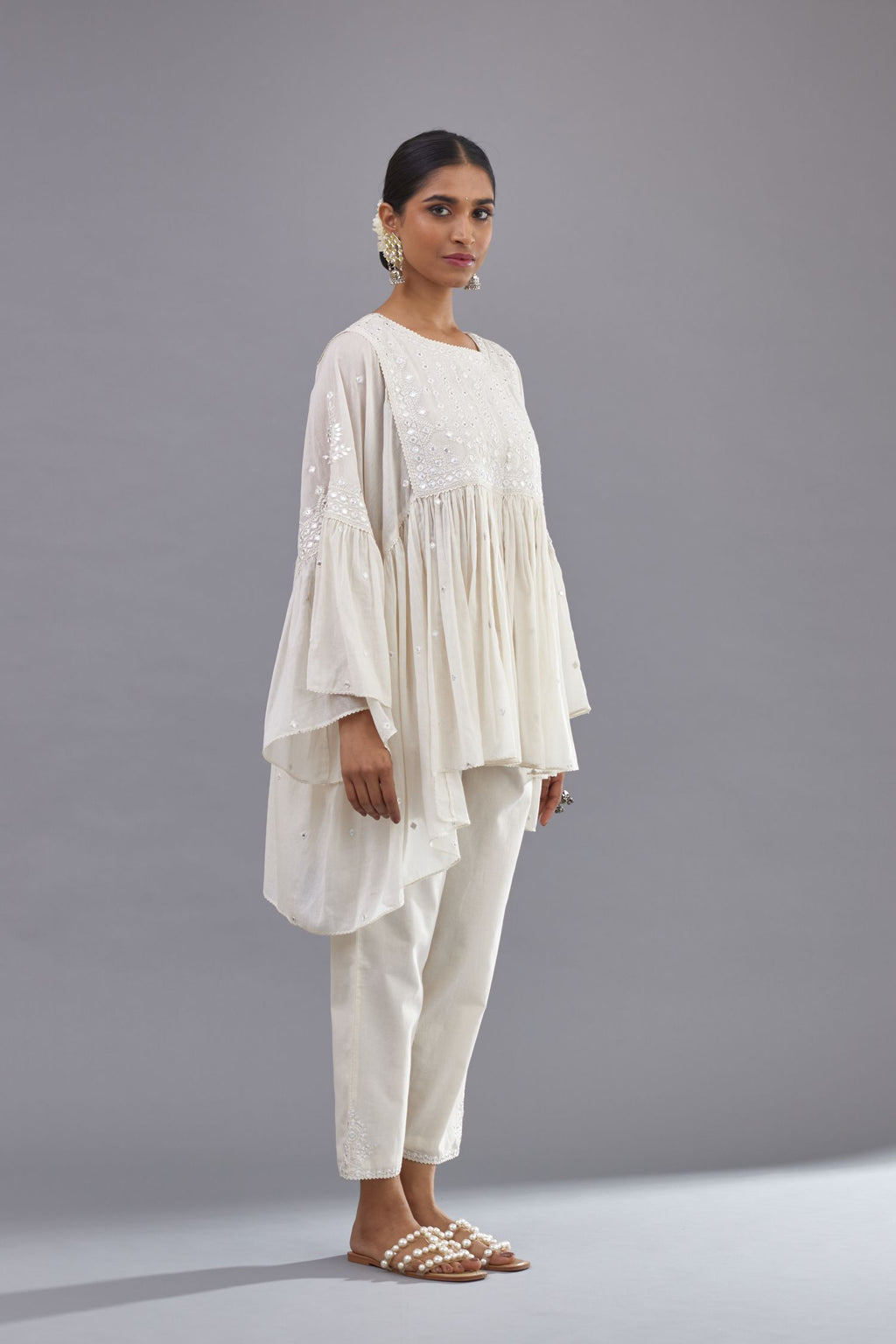 Off white cotton easy fit top with flared sleeves and hem, paired with off white cotton comfortable fit pant with all-over elasticated waistband.