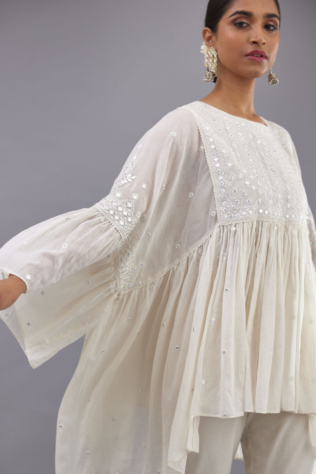 Off white cotton easy fit top with flared sleeves and hem, paired with off white cotton comfortable fit pant with all-over elasticated waistband.