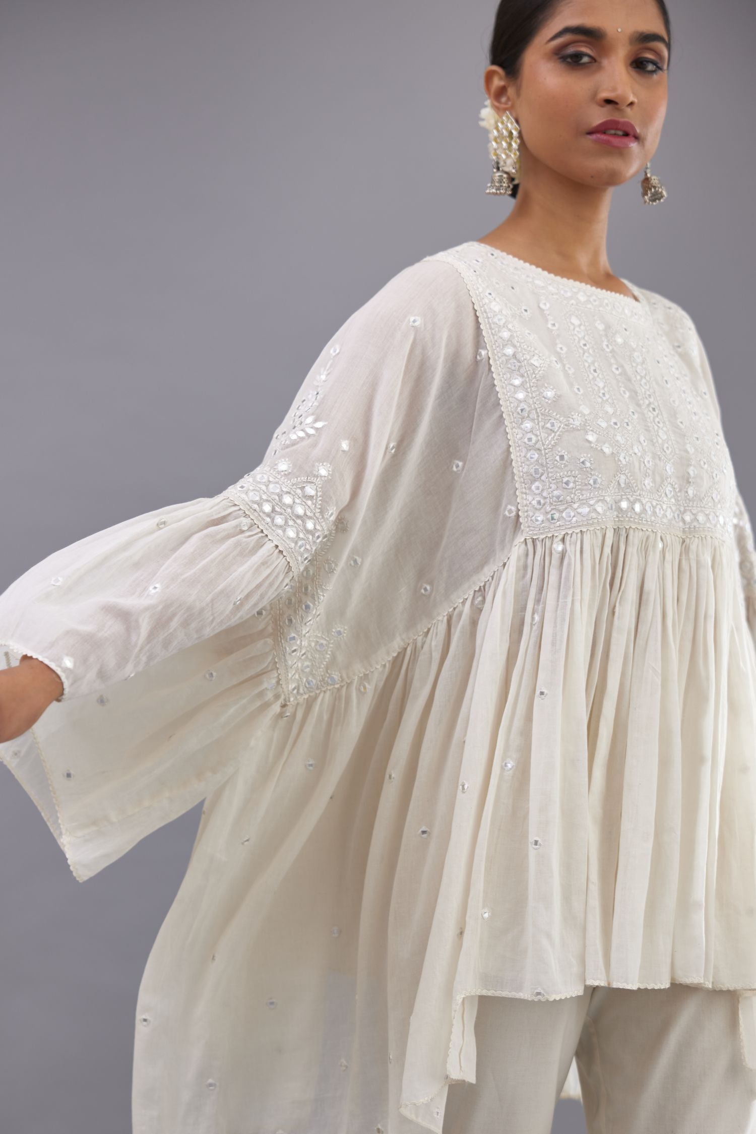 Off white cotton easy fit top with flared sleeves and hem, paired with off white cotton comfortable fit pant with all-over elasticated waistband.