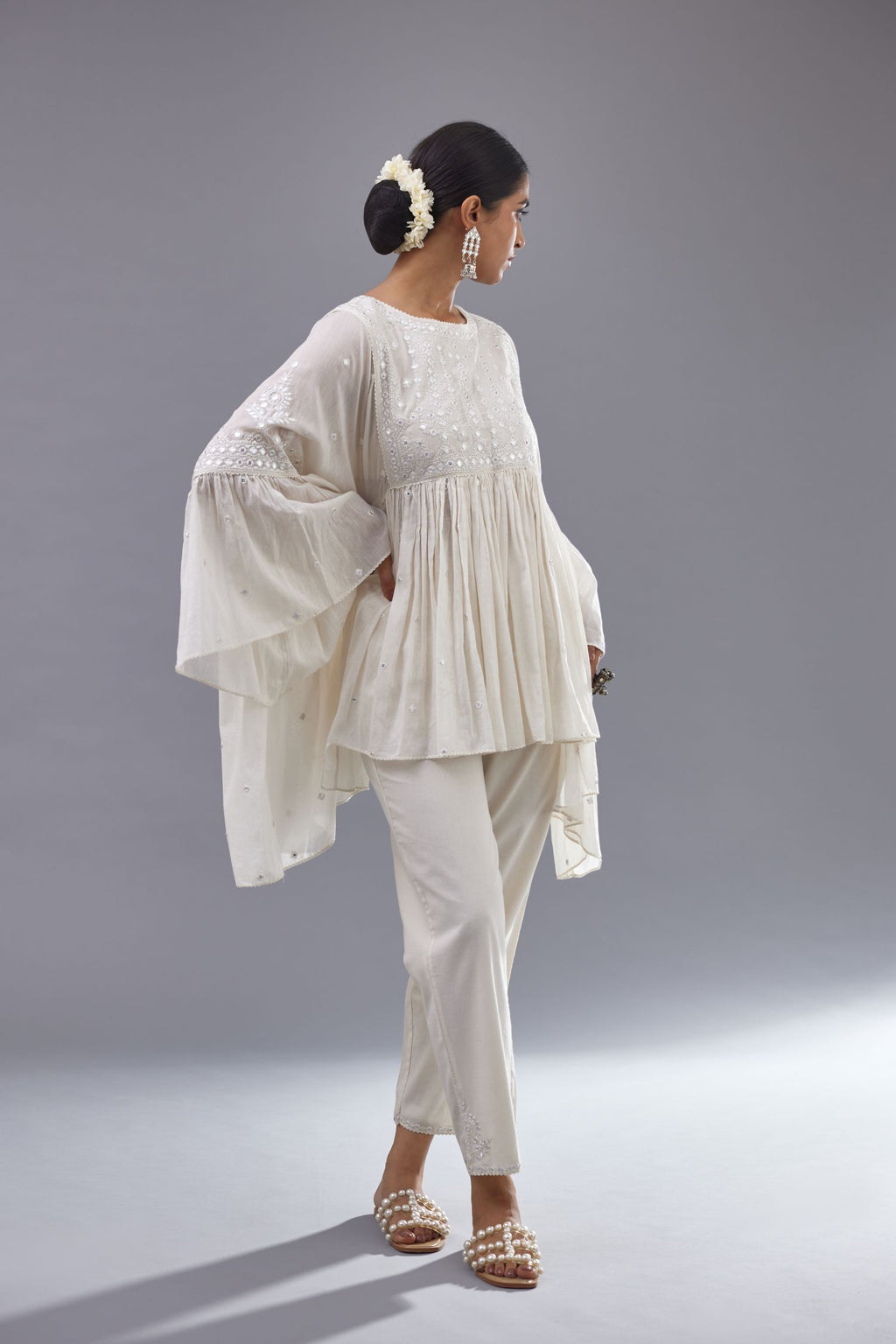 Off white cotton easy fit top with flared sleeves and hem, paired with off white cotton comfortable fit pant with all-over elasticated waistband.