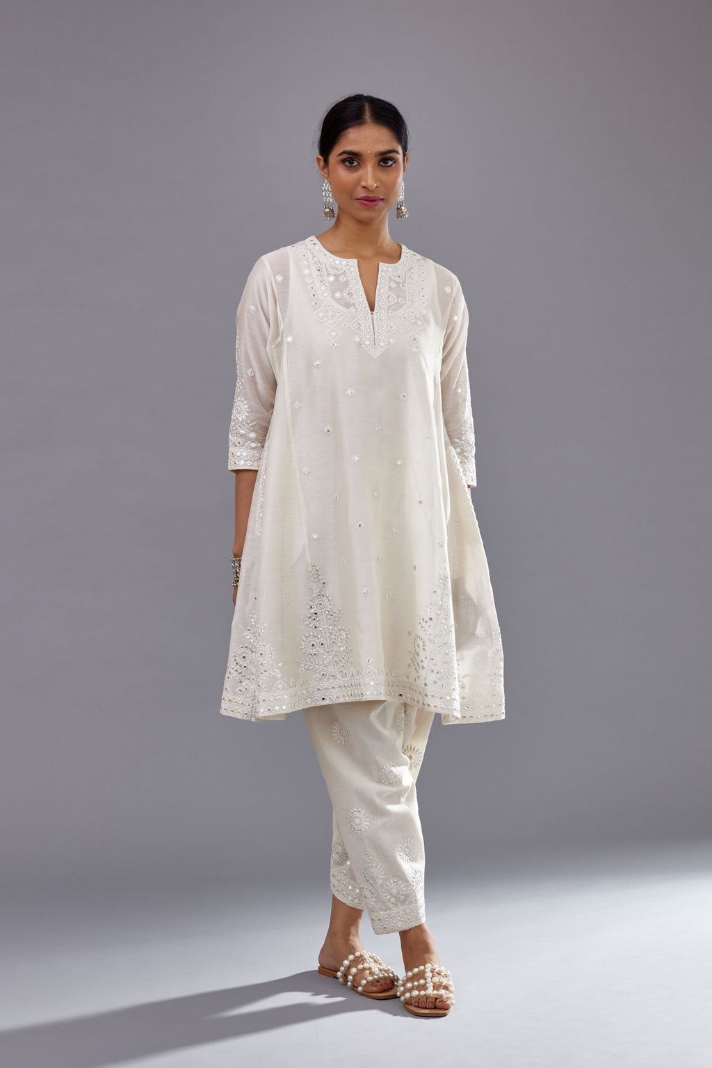 Off white silk Chanderi short panelled kurta set with off-white thread and mirror embroidery.