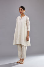 Off white silk Chanderi short panelled kurta set with off-white thread and mirror embroidery.