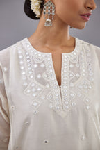 Off white silk Chanderi short panelled kurta set with off-white thread and mirror embroidery.