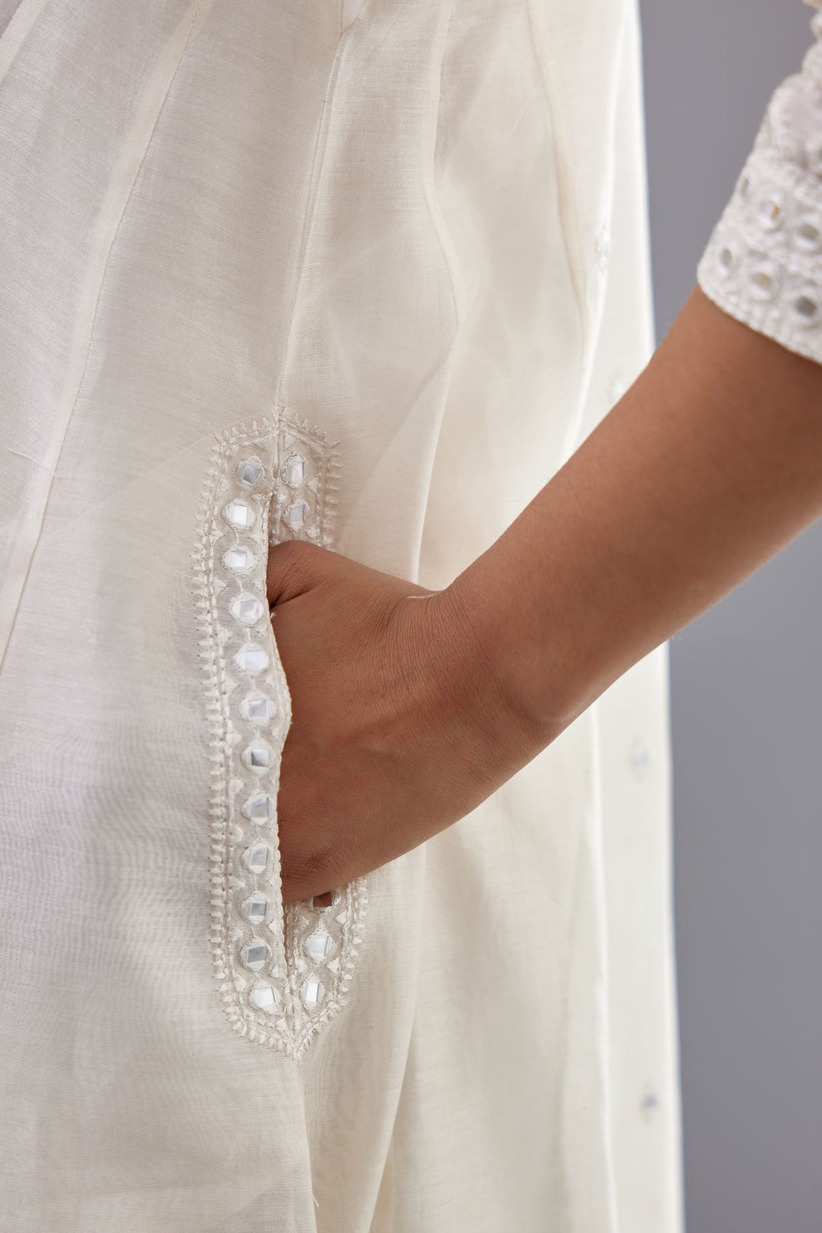 Off white silk Chanderi short panelled kurta set with off-white thread and mirror embroidery.
