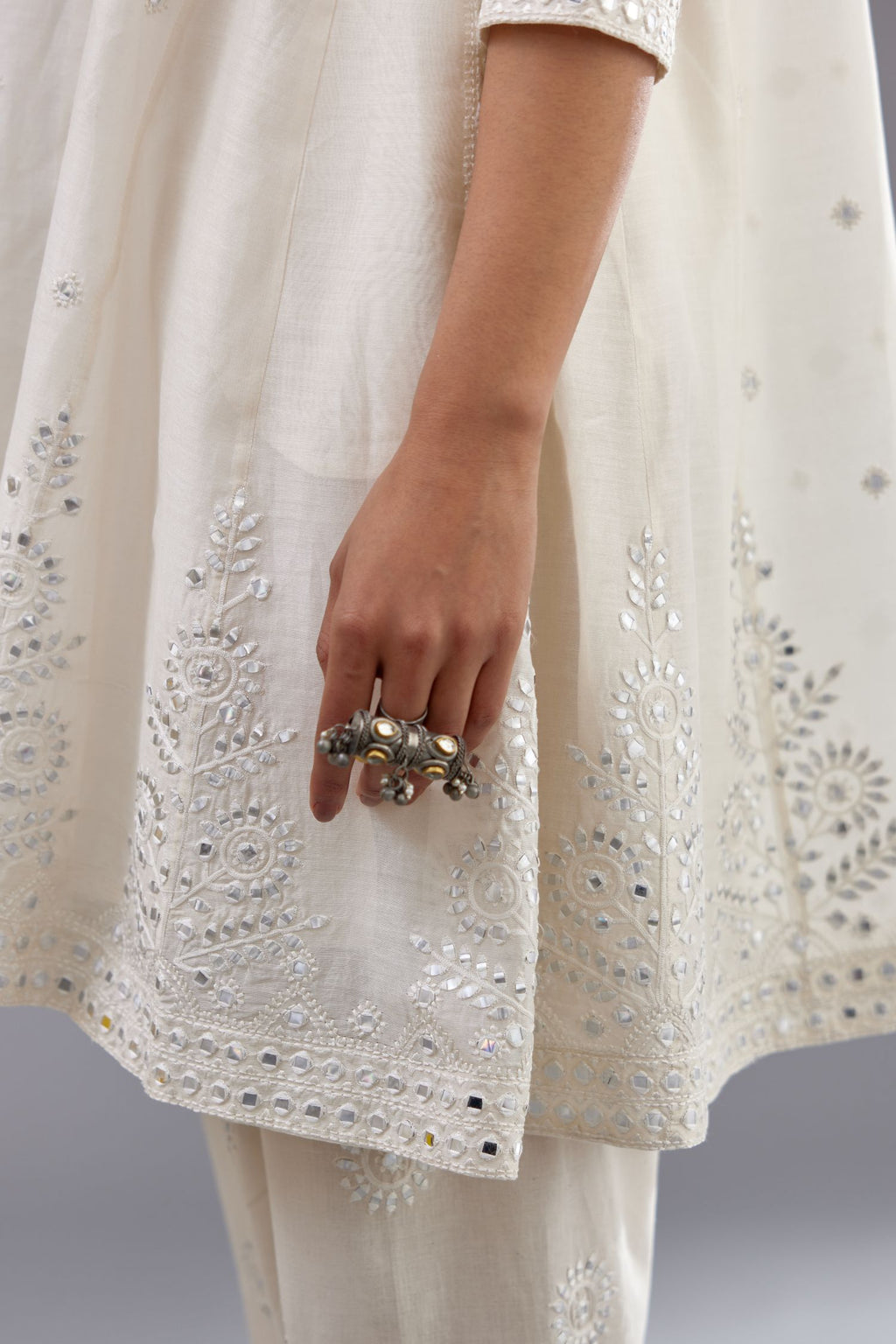 Off white silk Chanderi short panelled kurta set with off-white thread and mirror embroidery.