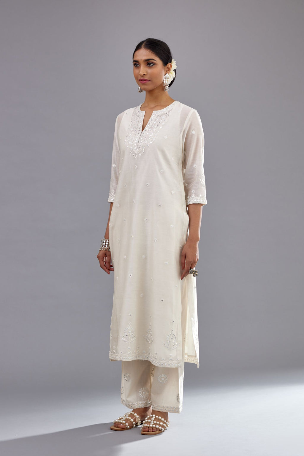 Off white silk Chanderi straight long kurta set with round neck, highlighted with off-white thread and mirror embroidery.