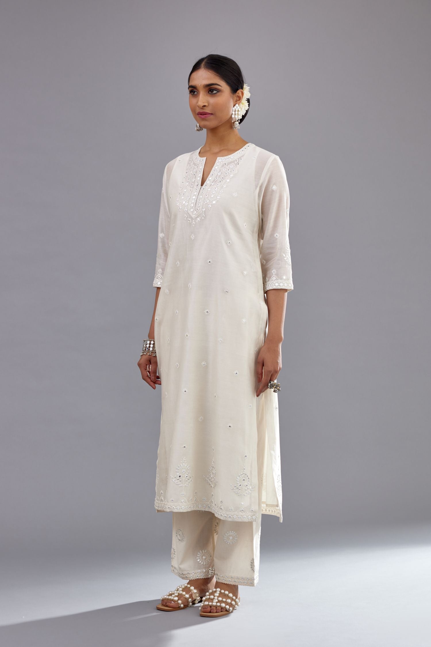 Off white silk Chanderi straight long kurta set with round neck, highlighted with off-white thread and mirror embroidery.