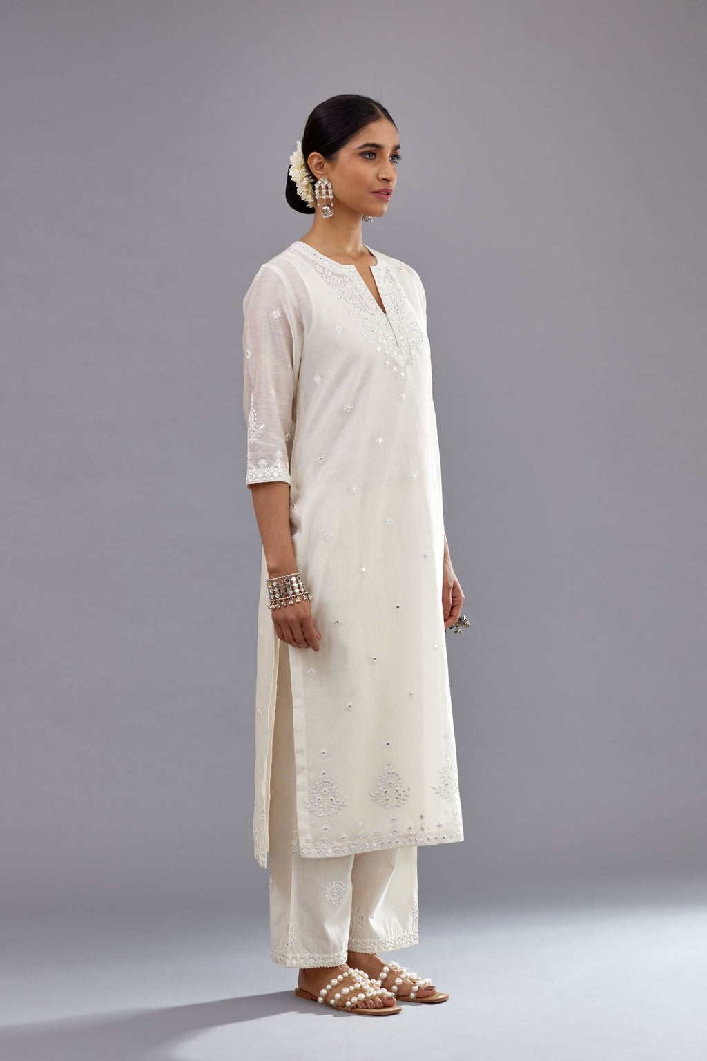 Off white silk Chanderi straight long kurta set with round neck, highlighted with off-white thread and mirror embroidery.
