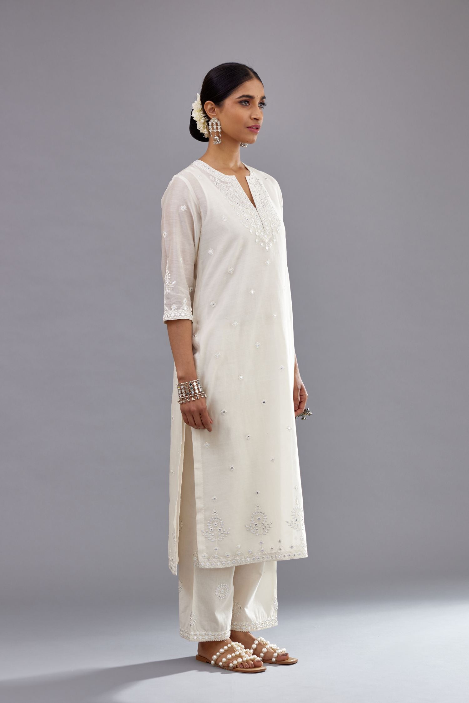 Off white silk Chanderi straight long kurta set with round neck, highlighted with off-white thread and mirror embroidery.
