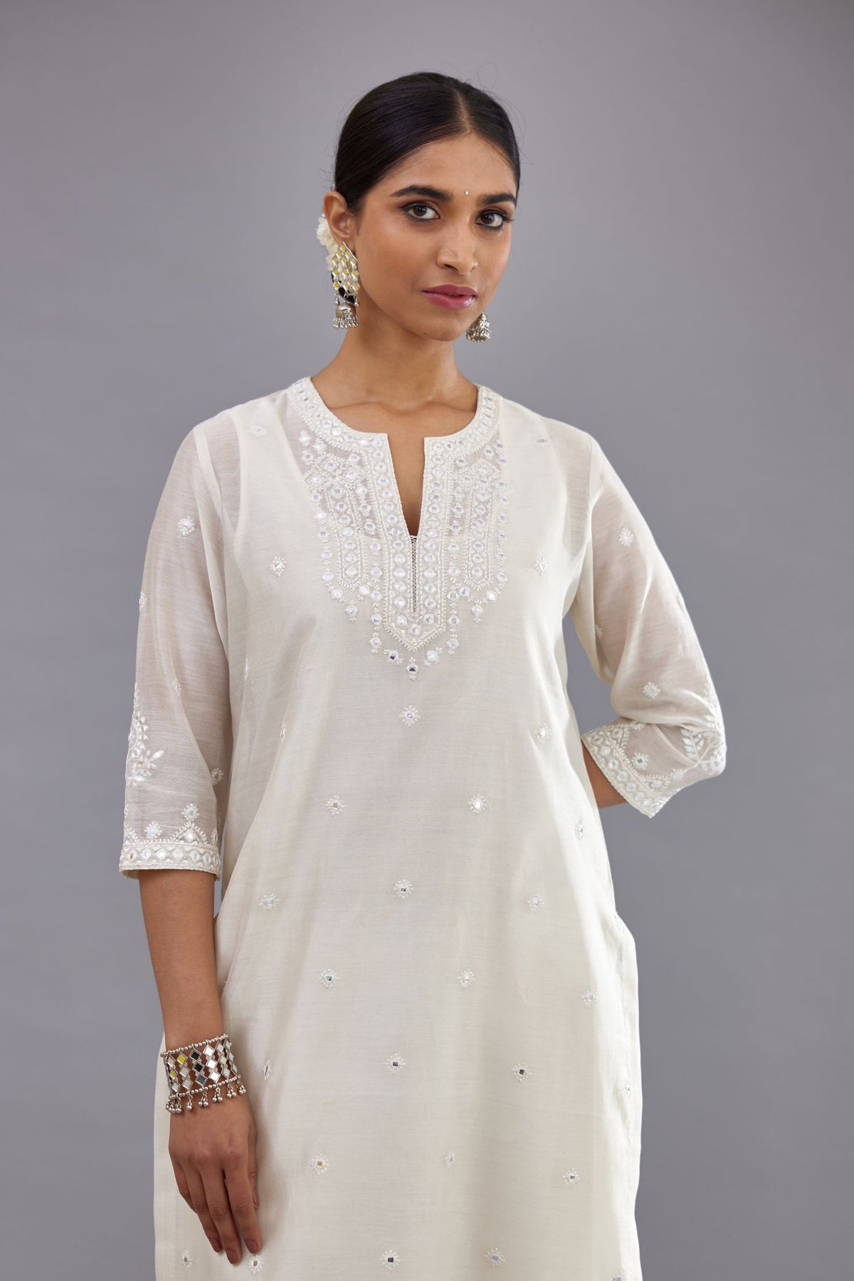 Off white silk Chanderi straight long kurta set with round neck, highlighted with off-white thread and mirror embroidery.