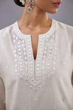 Off white silk Chanderi straight long kurta set with round neck, highlighted with off-white thread and mirror embroidery.