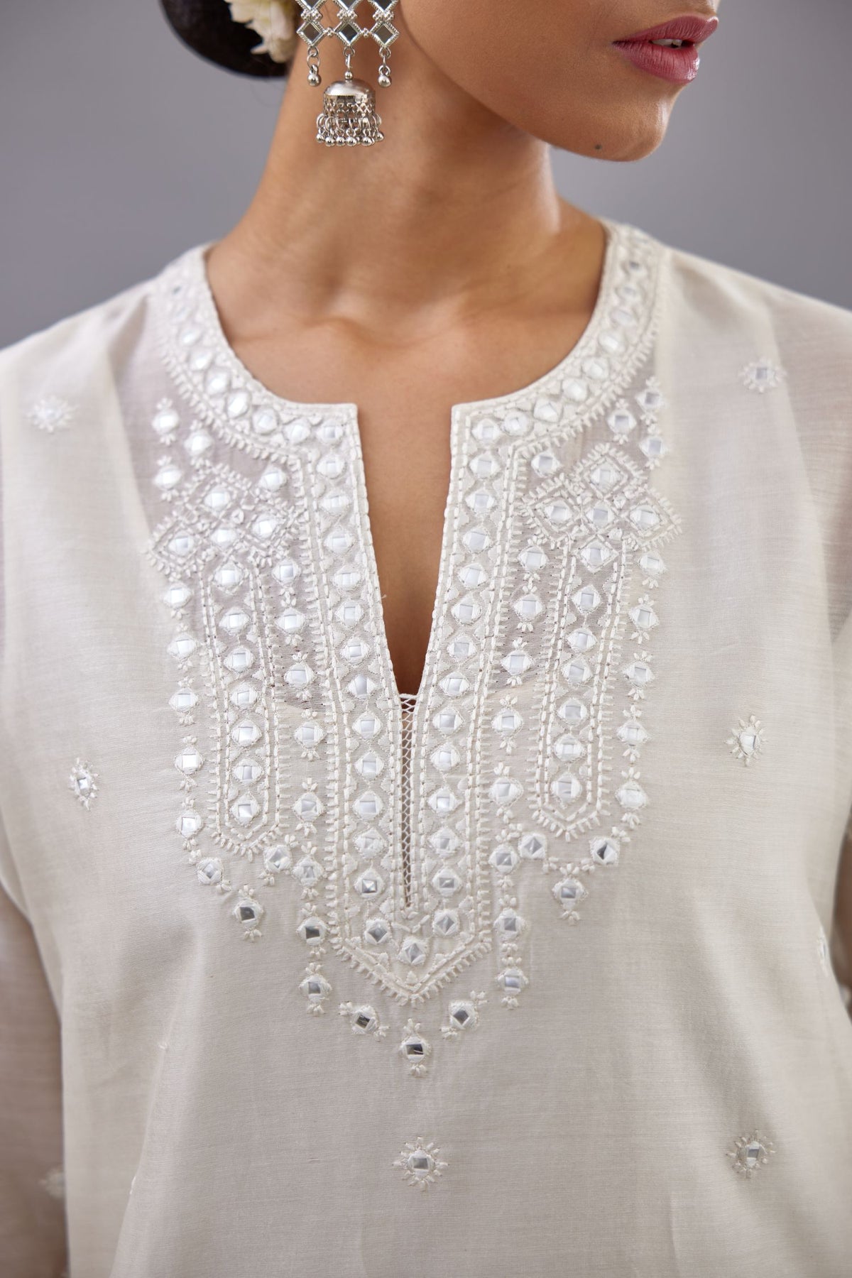 Off white silk Chanderi straight long kurta set with round neck, highlighted with off-white thread and mirror embroidery.