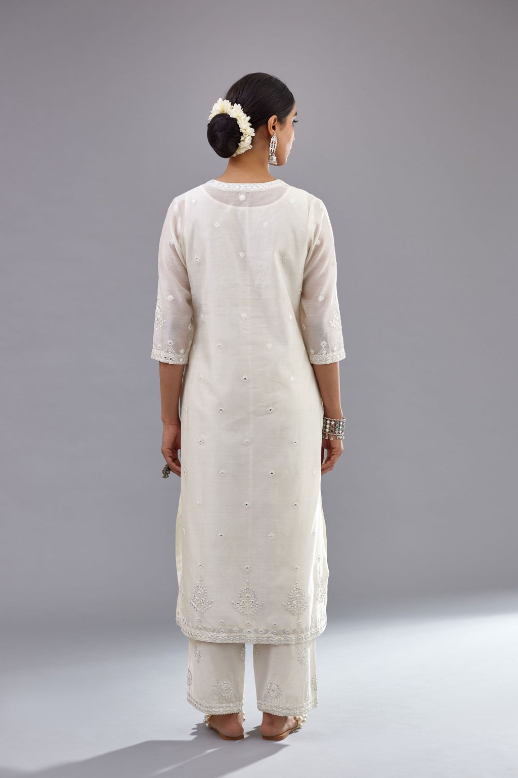 Off white silk Chanderi straight long kurta set with round neck, highlighted with off-white thread and mirror embroidery.