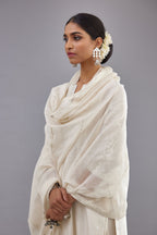 Off white silk Chanderi straight long kurta set with round neck, highlighted with off-white thread and mirror embroidery.