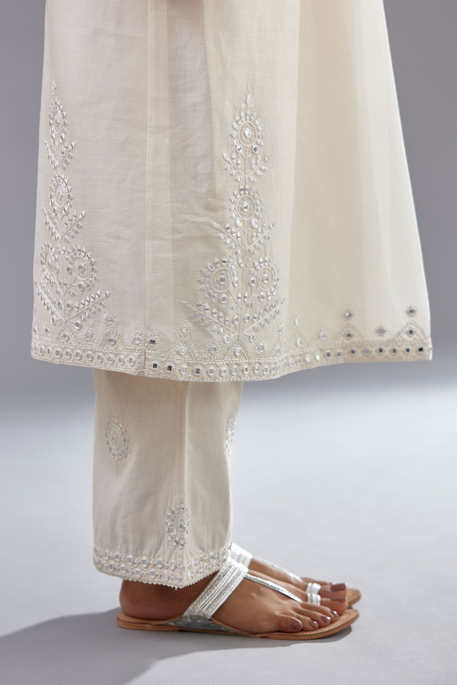 Off white silk Chanderi straight long kurta dress set with off-white thread and mirror embroidery.