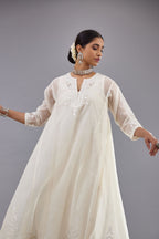 Off white Cotton Chanderi panelled and asymmetric hem long kurta set with off-white thread and mirror embroidery.