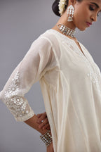 Off white Cotton Chanderi panelled and asymmetric hem long kurta set with off-white thread and mirror embroidery.