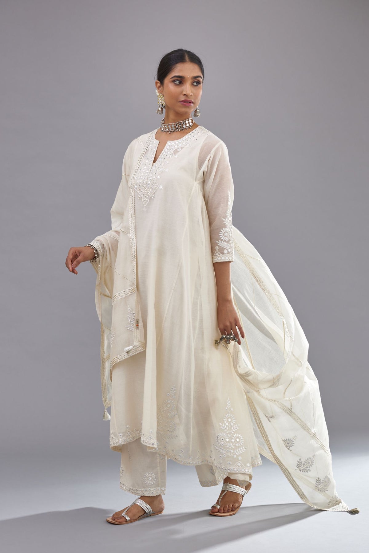 Off white Cotton Chanderi panelled and asymmetric hem long kurta set with off-white thread and mirror embroidery.