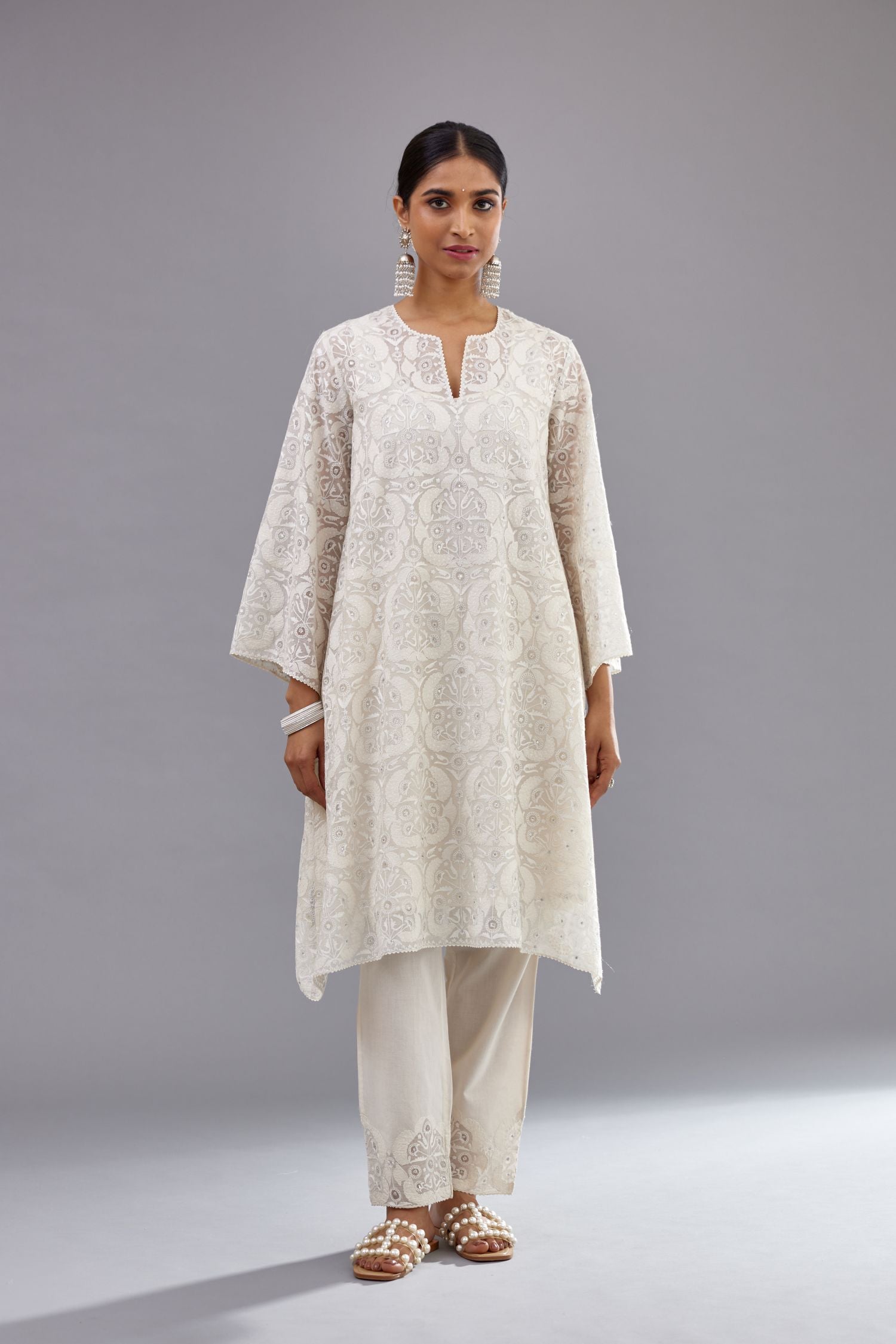 Off white short easy fit, straight hem kurta set with all-over trellis jaal appliqué, highlighted with sequins.