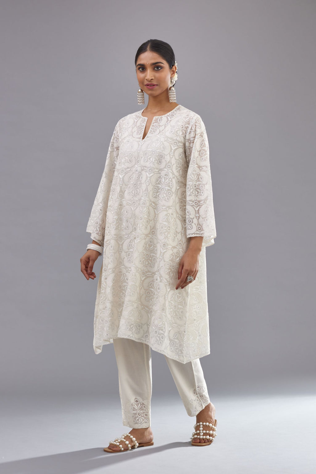 Off white short easy fit, straight hem kurta set with all-over trellis jaal appliqué, highlighted with sequins.