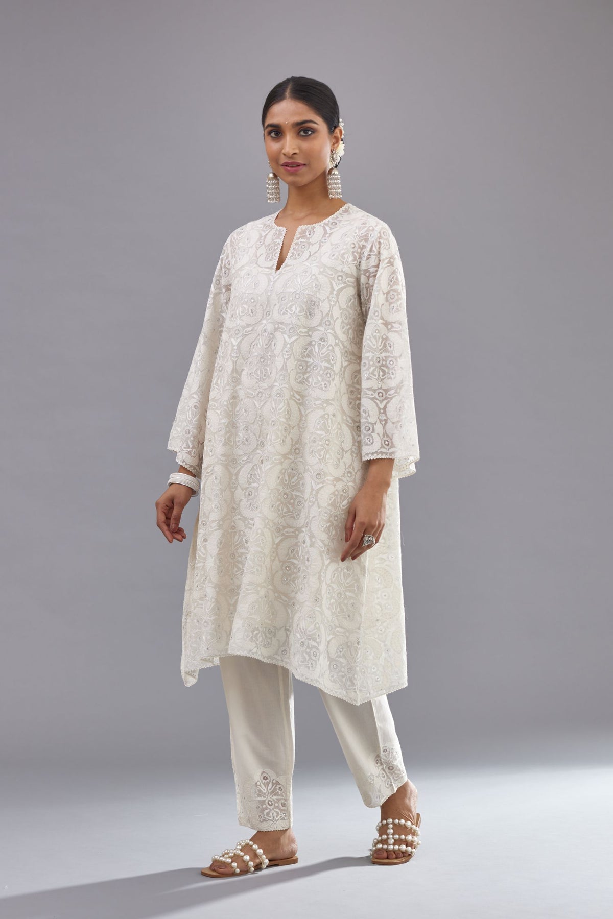 Off white short easy fit, straight hem kurta set with all-over trellis jaal appliqué, highlighted with sequins.