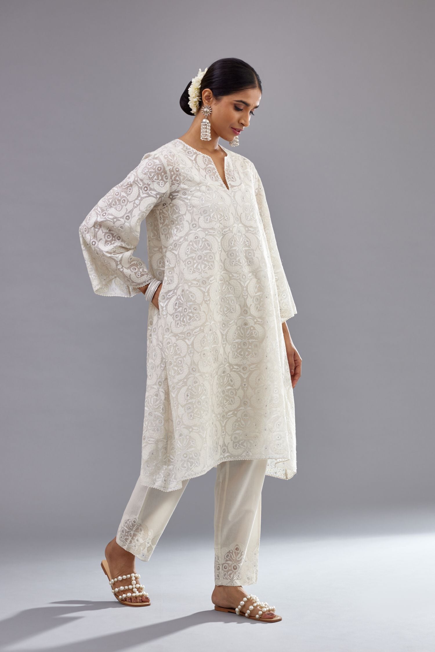 Off white short easy fit, straight hem kurta set with all-over trellis jaal appliqué, highlighted with sequins.