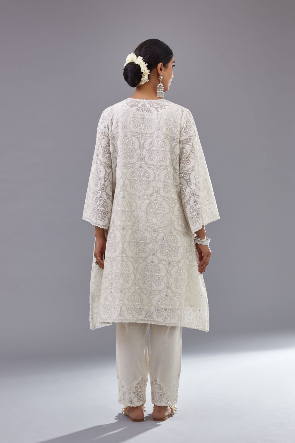 Off white short easy fit, straight hem kurta set with all-over trellis jaal appliqué, highlighted with sequins.