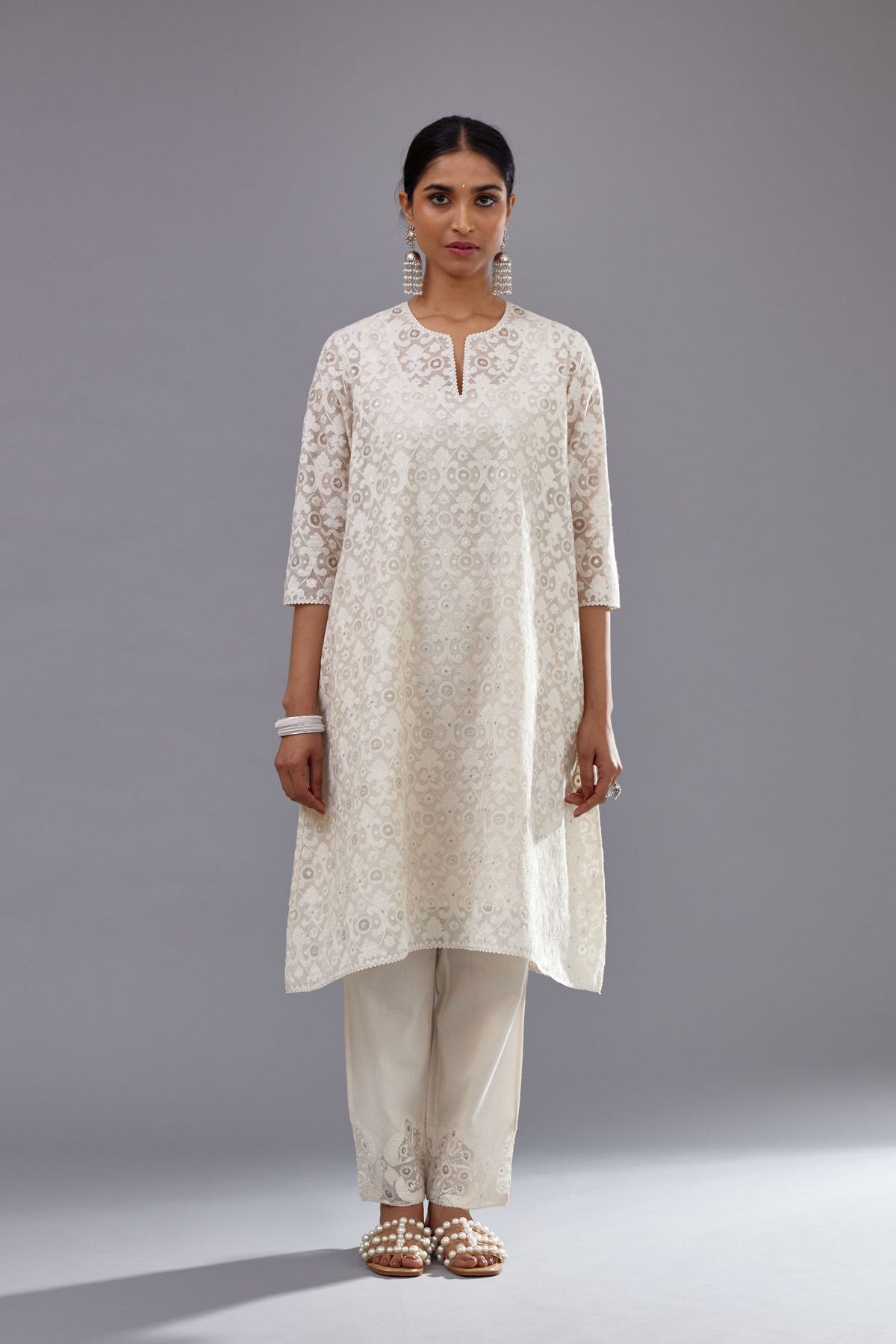 Off white short easy fit, straight hem kurta set with all-over trellis jaal appliqué, highlighted with sequins.