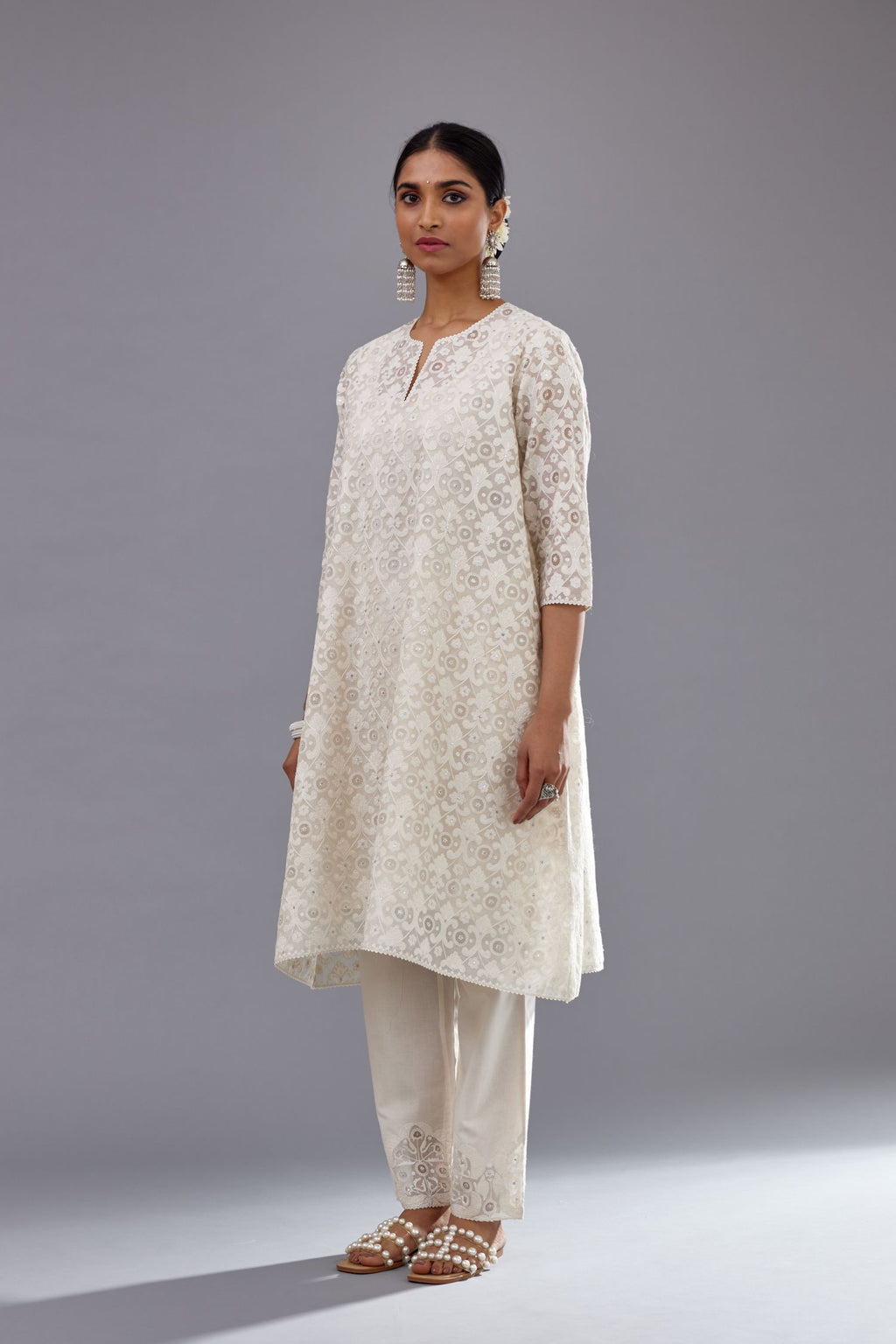 Off white short easy fit, straight hem kurta set with all-over trellis jaal appliqué, highlighted with sequins.