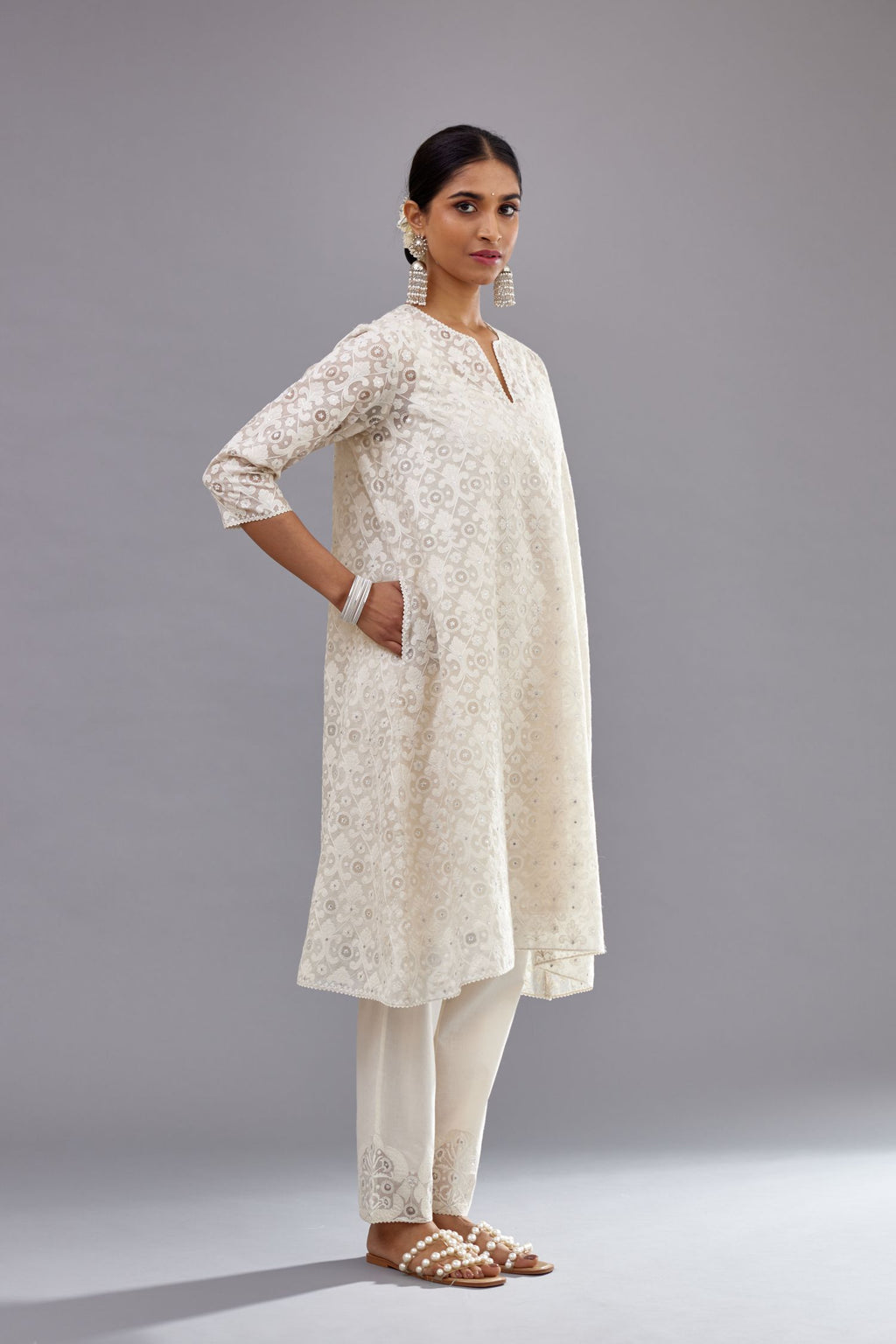 Off white short easy fit, straight hem kurta set with all-over trellis jaal appliqué, highlighted with sequins.