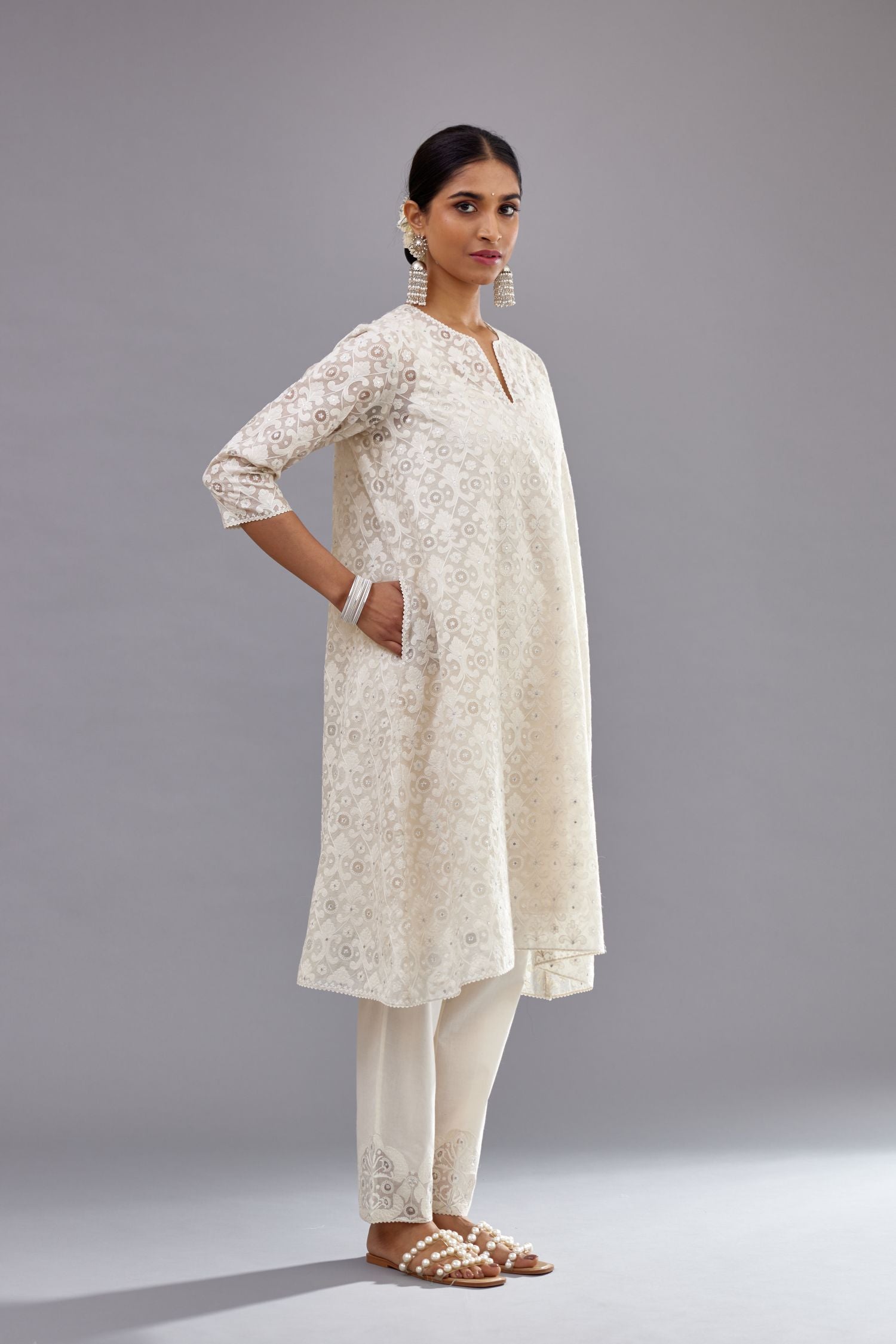 Off white short easy fit, straight hem kurta set with all-over trellis jaal appliqué, highlighted with sequins.