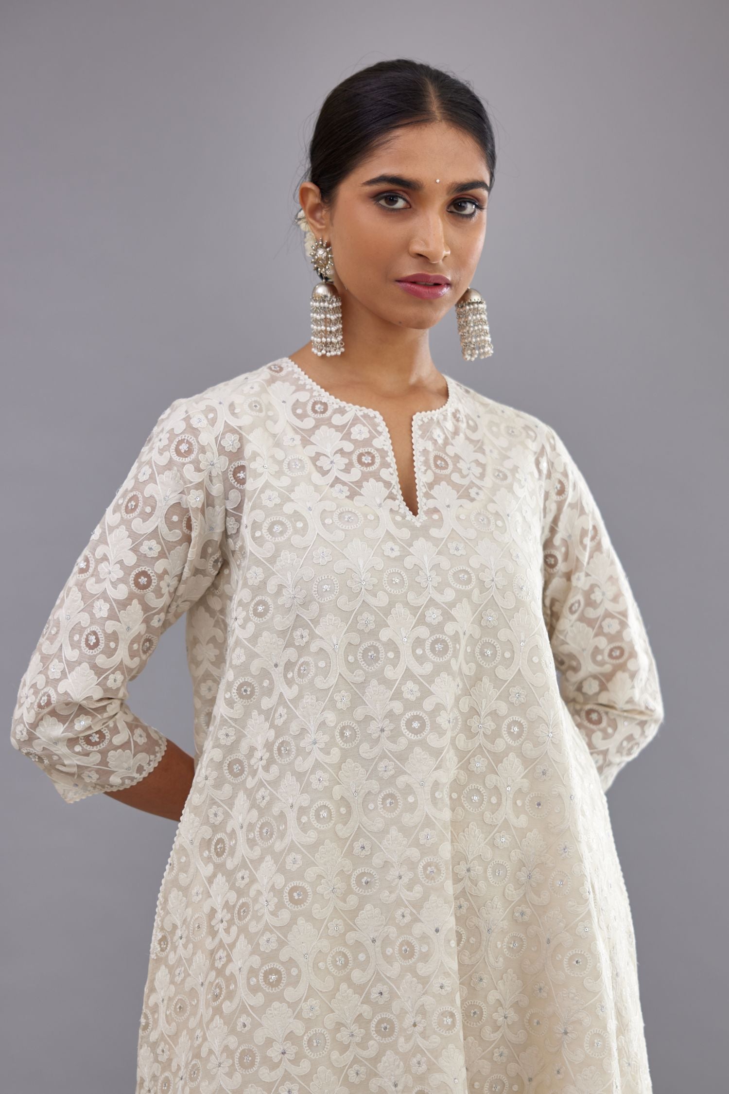 Off white short easy fit, straight hem kurta set with all-over trellis jaal appliqué, highlighted with sequins.