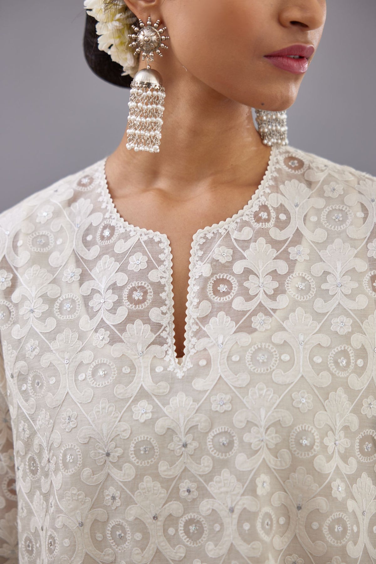 Off white short easy fit, straight hem kurta set with all-over trellis jaal appliqué, highlighted with sequins.