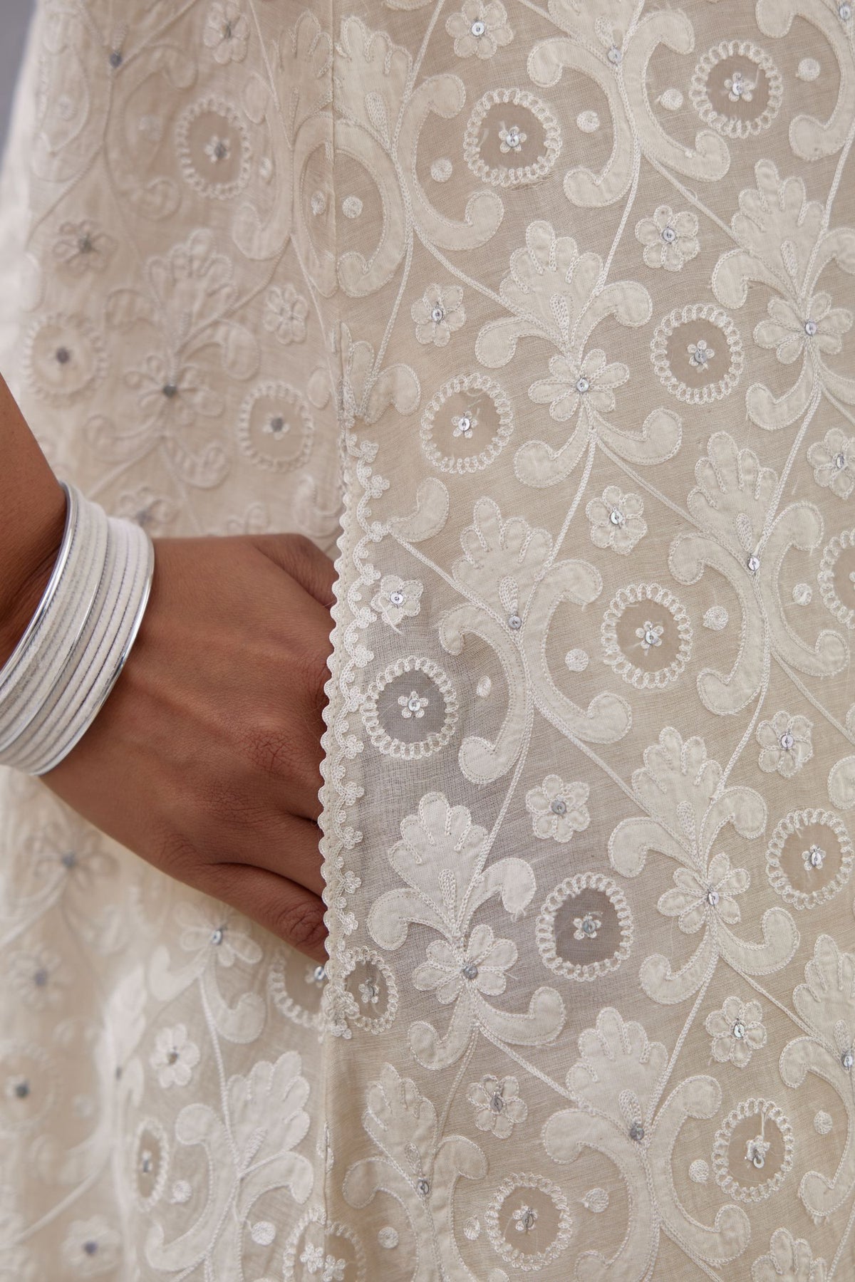 Off white short easy fit, straight hem kurta set with all-over trellis jaal appliqué, highlighted with sequins.