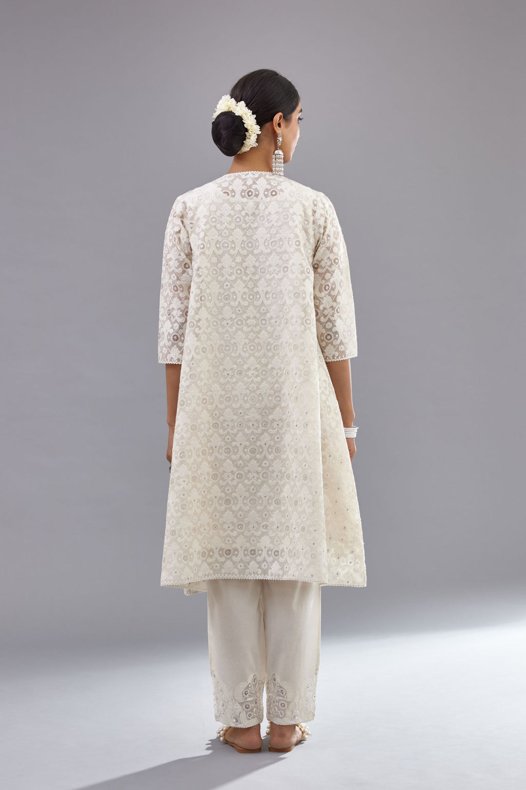 Off white short easy fit, straight hem kurta set with all-over trellis jaal appliqué, highlighted with sequins.