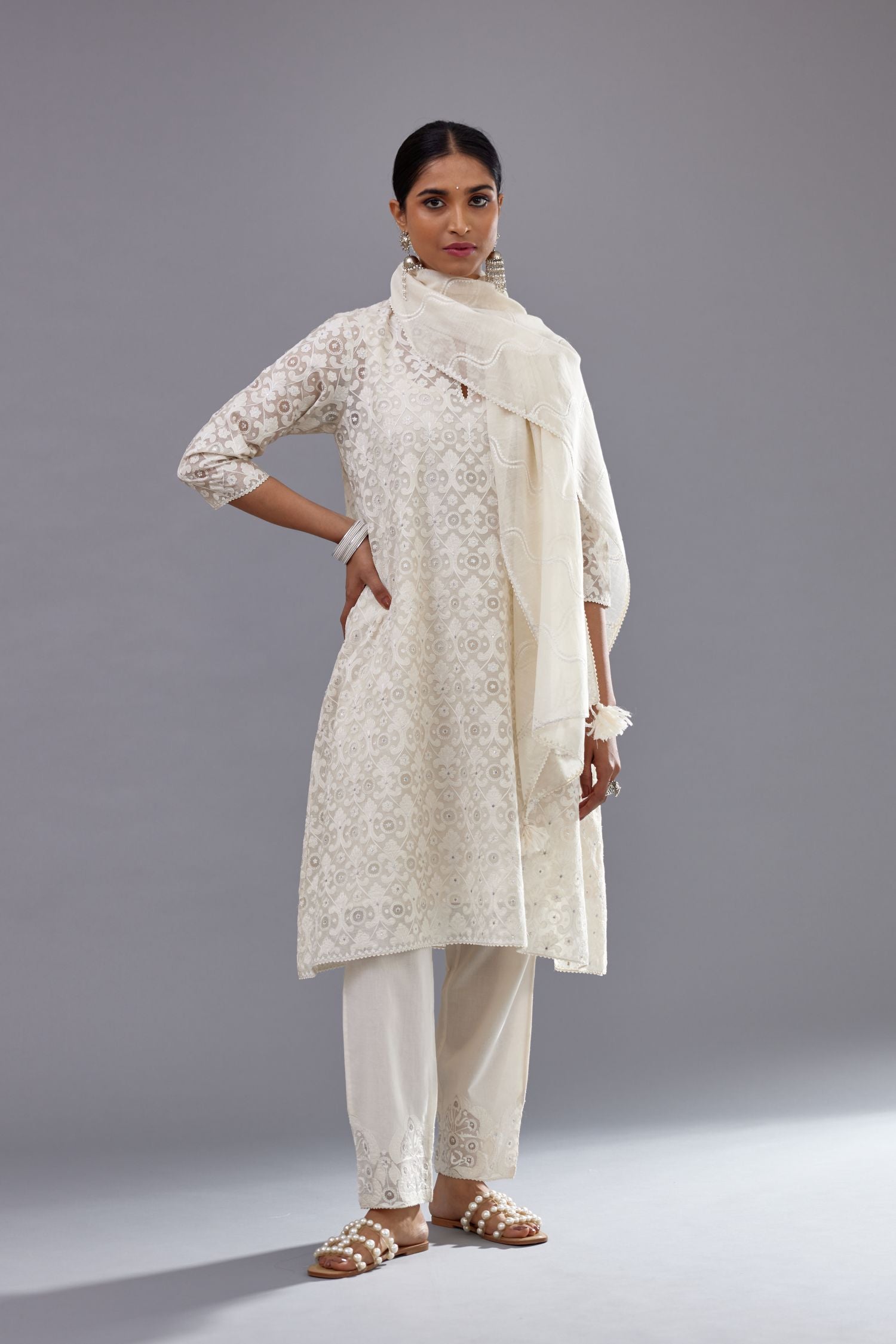 Off white short easy fit, straight hem kurta set with all-over trellis jaal appliqué, highlighted with sequins.