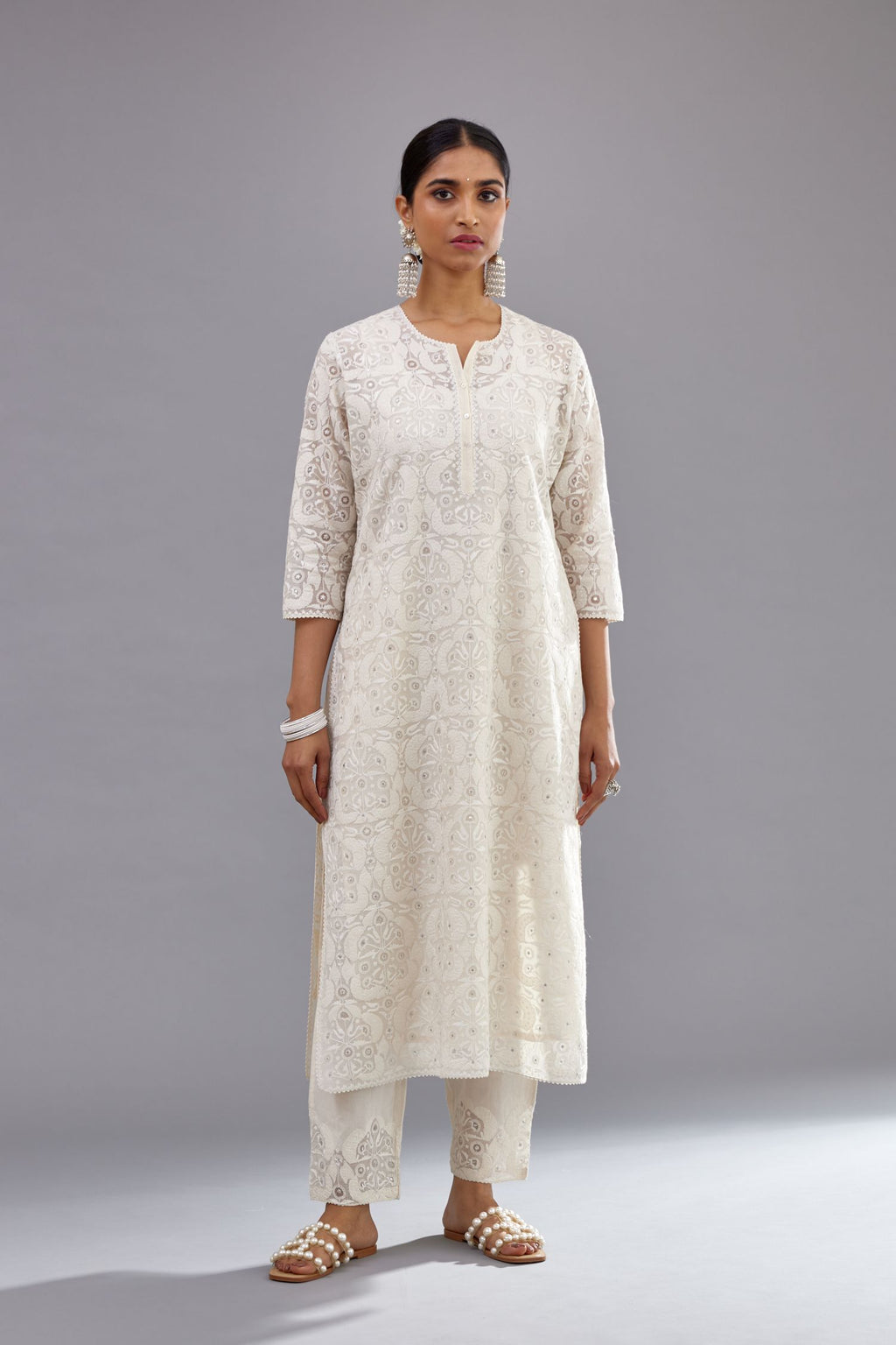 Off white straight kurta set with all-over cotton appliqué trellis jaal, highlighted with sequins.