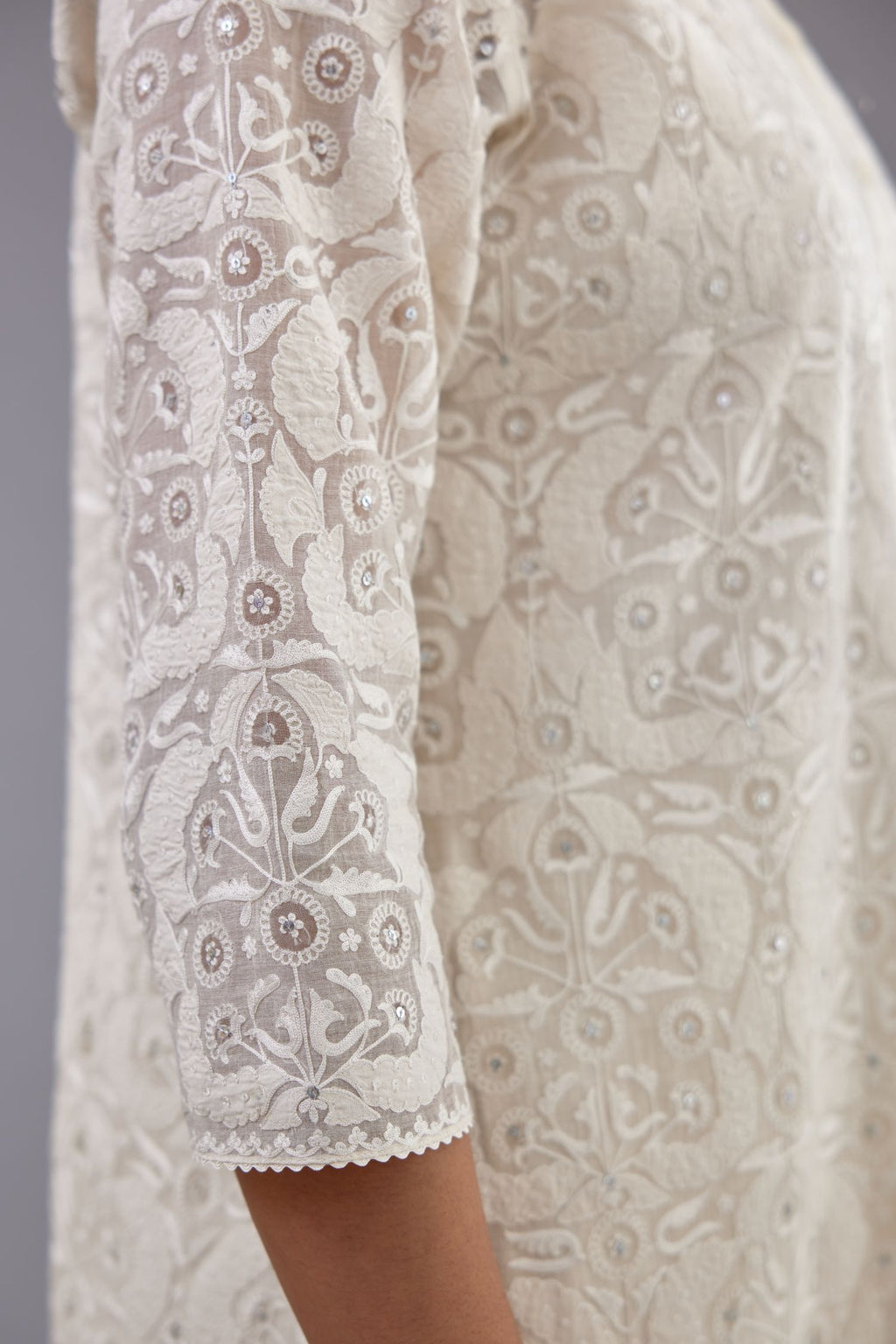 Off white straight kurta set with all-over cotton appliqué trellis jaal, highlighted with sequins.