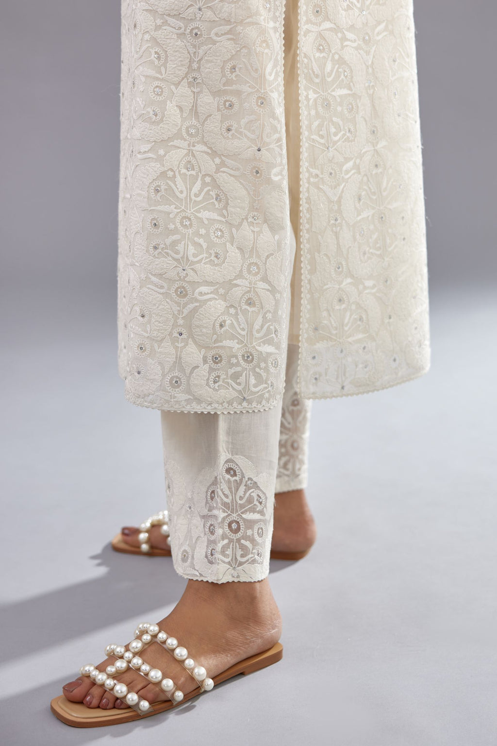 Off white straight kurta set with all-over cotton appliqué trellis jaal, highlighted with sequins.