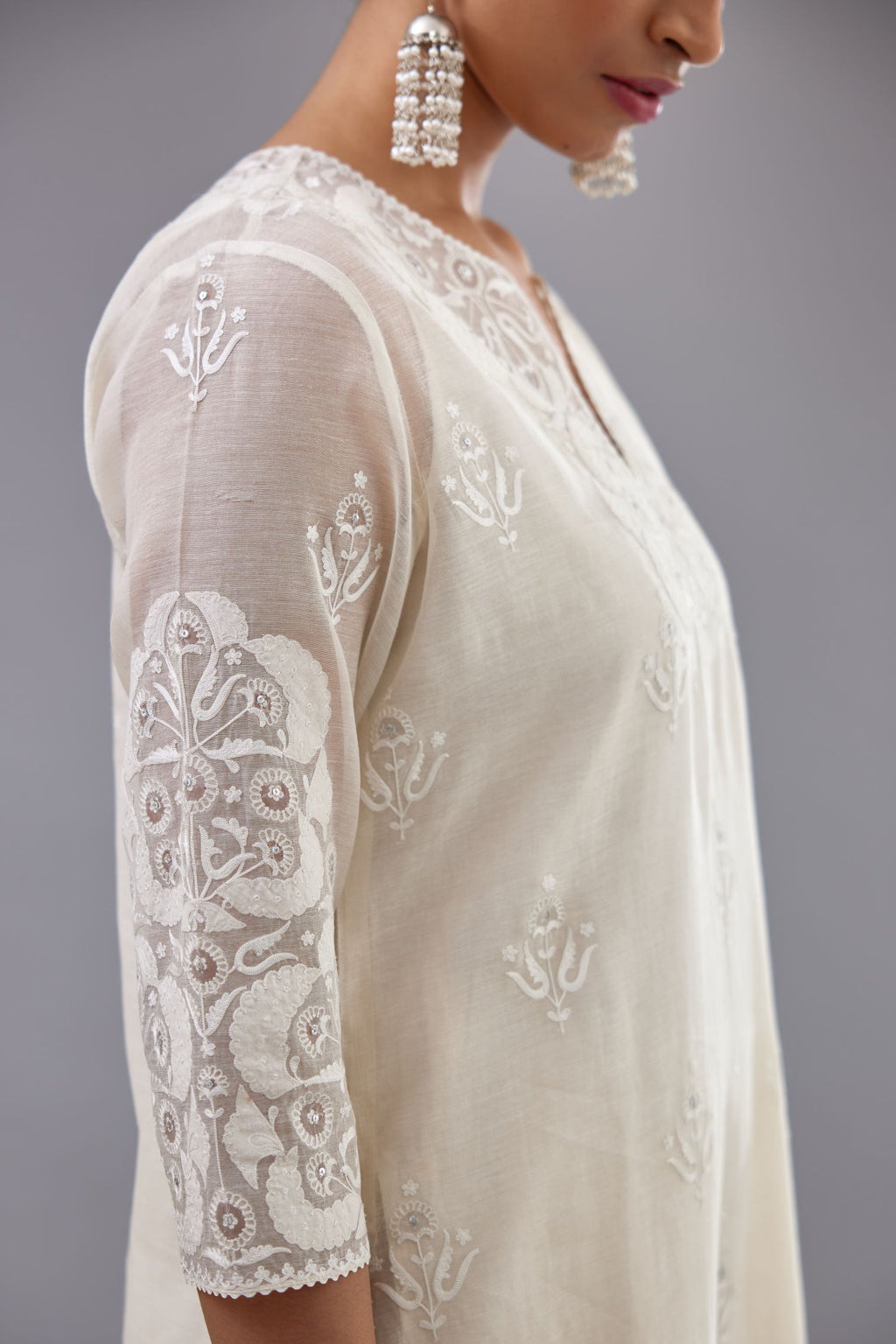 Off white cotton chanderi straight kurta set with cotton appliqué, highlighted with sequins.